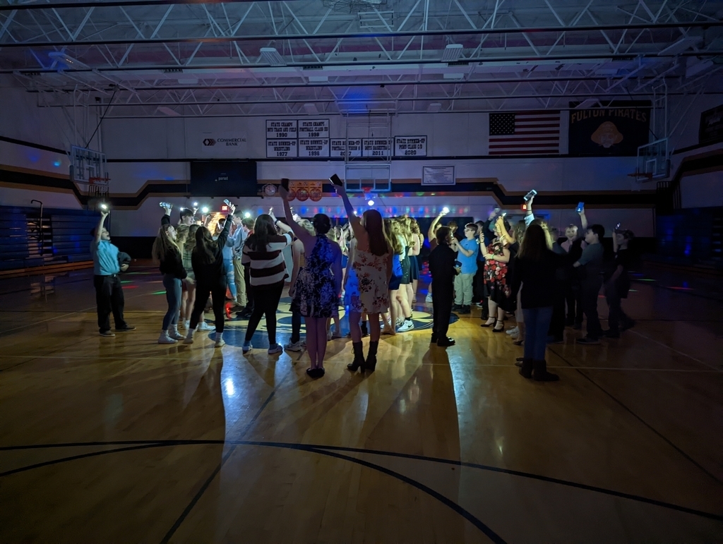 Students dancing on a gymnasium floor.